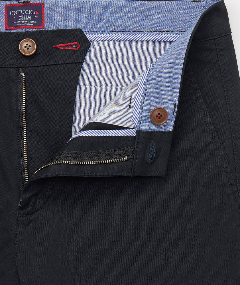 Model is wearing UNTUCKit Classic Chino Pants in black.