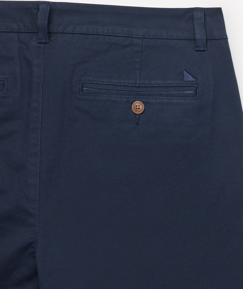 Model is wearing UNTUCKit Classic Chino Pants in Navy.