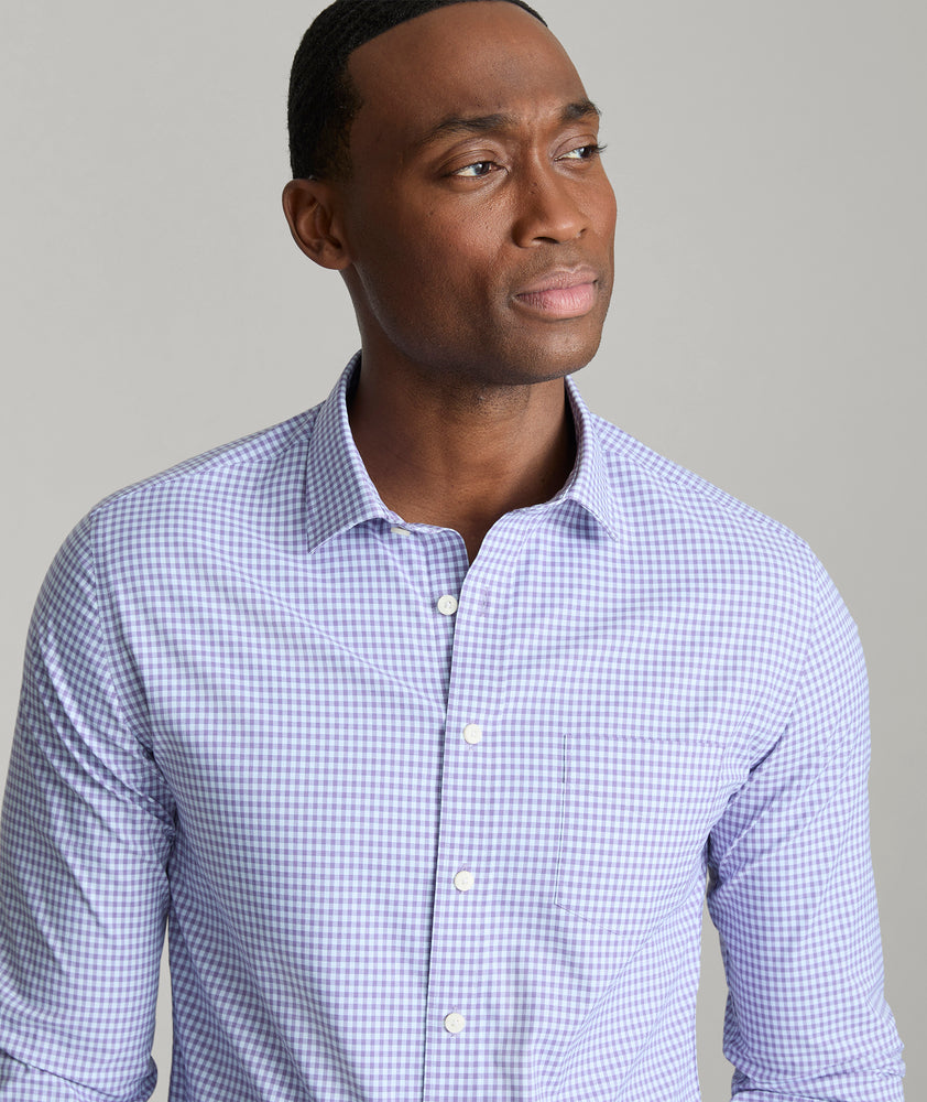 Model is wearing UNTUCKit Starling performance shirt in purple.