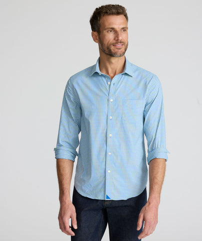 Model is wearing UNTUCKit Starling performance shirt in blue green.