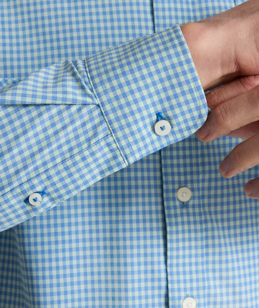 Model is wearing UNTUCKit Starling performance shirt in blue green.