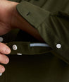Model is wearing UNTUCKit Sullivan wrinkle-free knit shirt in forest green. 