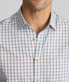 Model is wearing UNTUCKit CottonTek Brachetto Shirt in Blue and Brown Check. 