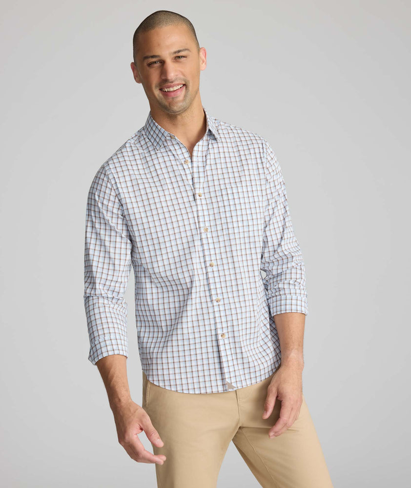 Model is wearing UNTUCKit CottonTek Brachetto Shirt in Blue and Brown Check. 
