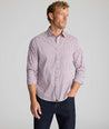 Model is wearing UNTUCKit CottonTek Brachetto Shirt in Burgundy Check. 