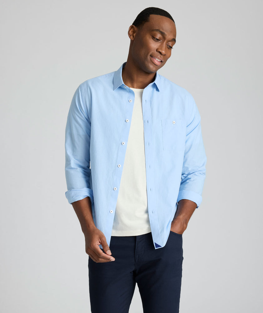 Model is wearing UNTUCKit Sutherland summer weight shirt in blue. 
