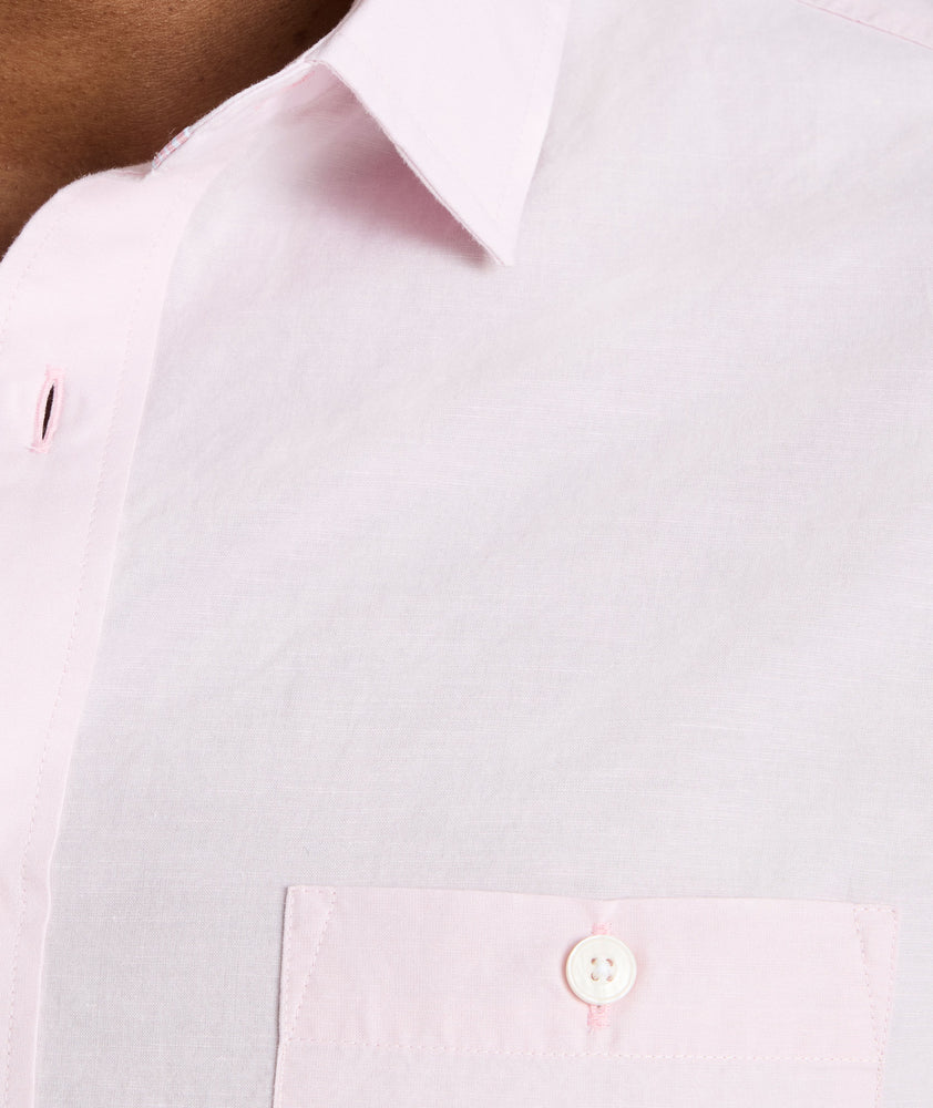 Model is wearing UNTUCKit Sutherland summer weight shirt in pink. 