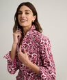 Model is wearing UNTUCKit Taylor dress in pink print.