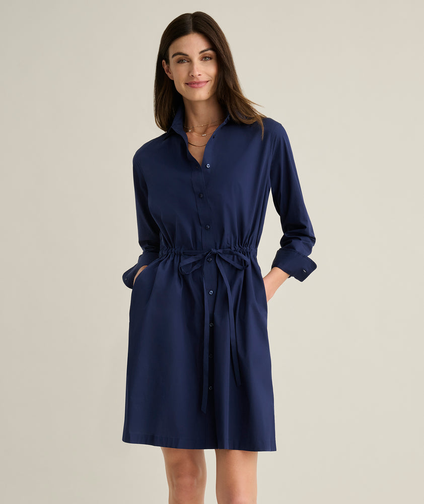 Model is wearing UNTUCKit Taylor dress in navy. 