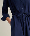 Model is wearing UNTUCKit Taylor dress in navy. 