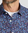 Model is wearing UNTUCKit Performance Short-Sleeve Tennyson Shirt in Multicolor Print.