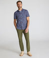 Model is wearing UNTUCKit Performance Short-Sleeve Tennyson Shirt in Multicolor Print.