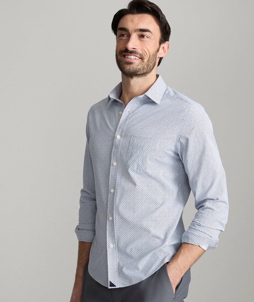 Model is wearing UNTUCKit Wrinkle-Free Performance Teramo Shirt in White & Navy Print.