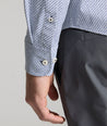 Model is wearing UNTUCKit Wrinkle-Free Performance Teramo Shirt in White & Navy Print.