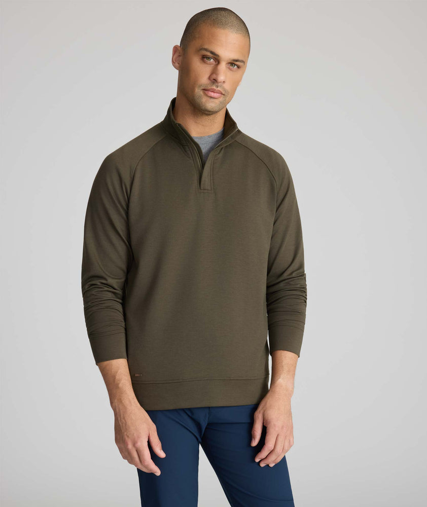 Model is wearing UNTUCKit Toovey Performance Quarter Zip  in Sea Turtle.