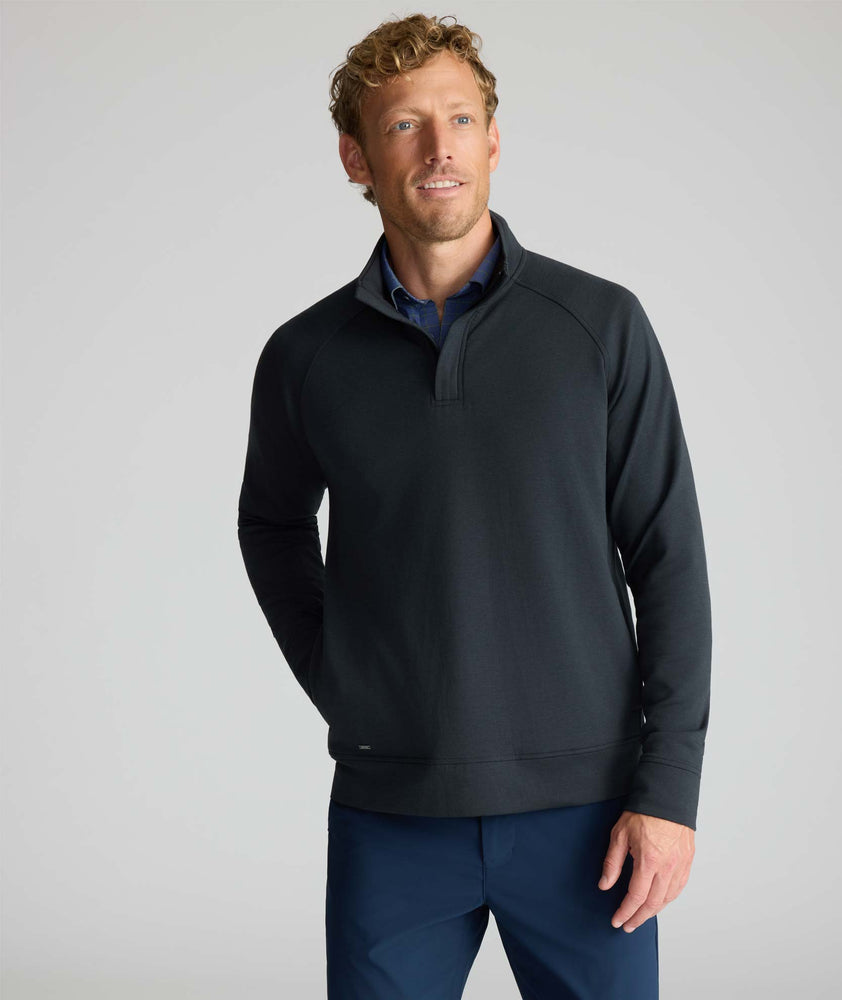 Model is wearing UNTUCKit Performance Mason Quarter Zip in Black.