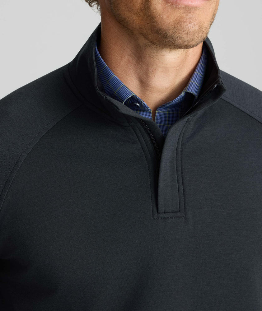 Model is wearing UNTUCKit Performance Mason Quarter Zip in Black.