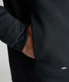 Model is wearing UNTUCKit Performance Mason Quarter Zip in Black.