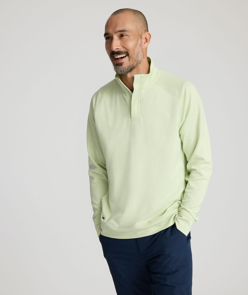 Model is wearing UNTUCKit Toovy Performance Quarter Zip in Fog Green.
