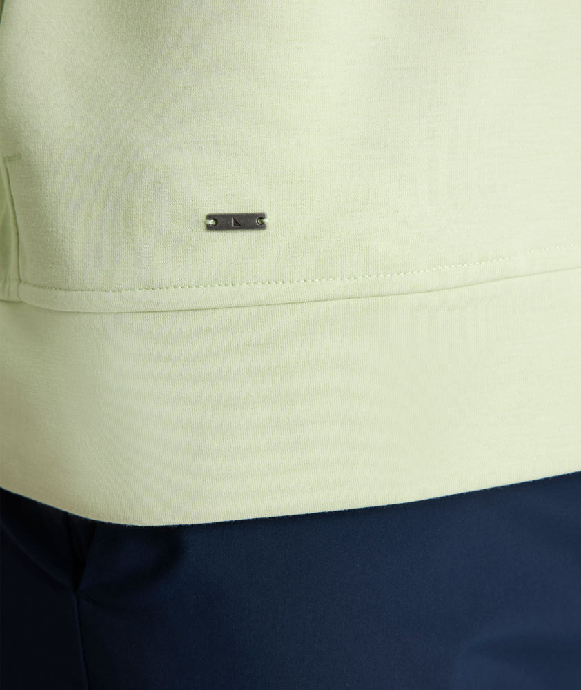 Model is wearing UNTUCKit Toovy Performance Quarter Zip in Fog Green.