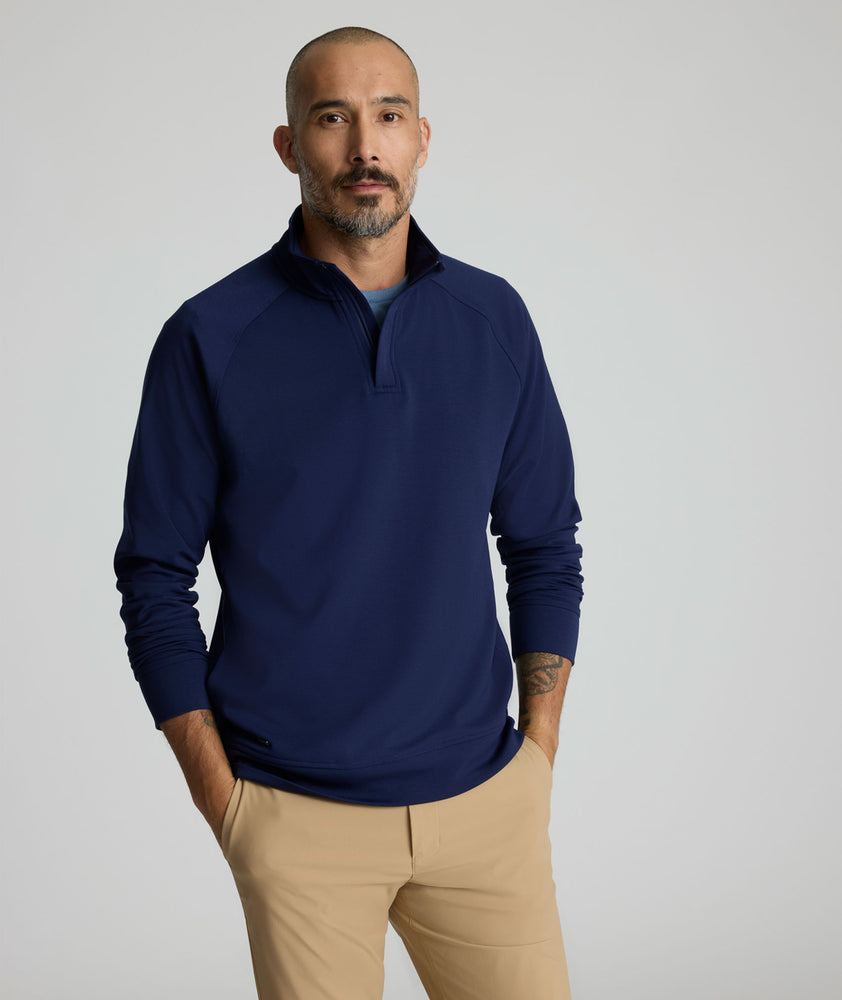 Model is wearing UNTUCKit Toovy Performance Quarter Zip in Evening Blue