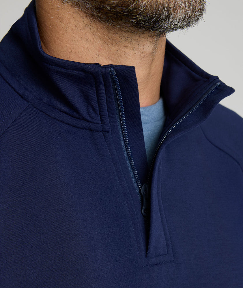 Model is wearing UNTUCKit Toovy Performance Quarter Zip in Evening Blue