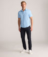 Model is wearing UNTUCKit Torre 5-Pocket Tech Pant in Black. 