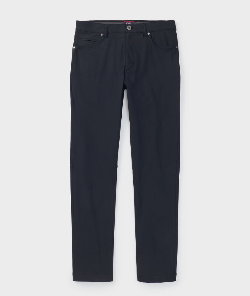 Model is wearing UNTUCKit Torre 5-Pocket Tech Pant in Black. 