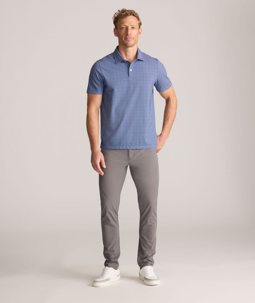 Model is wearing UNTUCKit 5-Pocket Performance Tech Pants in Gray.