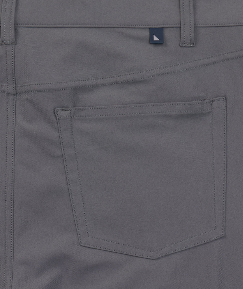 Model is wearing UNTUCKit 5-Pocket Performance Tech Pants in Gray.