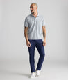 Model is wearing UNTUCKit 5-Pocket Performance Tech Pants in Navy.