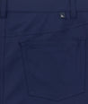 Model is wearing UNTUCKit 5-Pocket Performance Tech Pants in Navy.