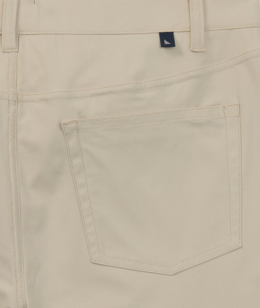 Model is wearing UNTUCKit 5-Pocket Performance Tech Pants in Tan.