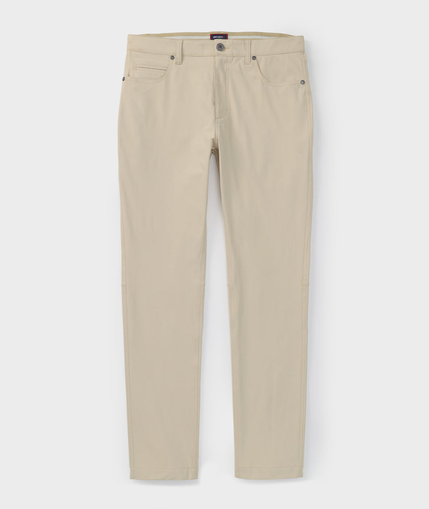 Model is wearing UNTUCKit 5-Pocket Performance Tech Pants in Tan.