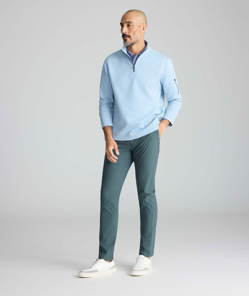 Model is wearing UNTUCKit traveler tech pants. 