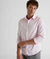 Model is wearing Travers shirt in pink. 
