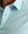 Model is wearing UNTUCKit Travelers shirt in purple tiny gingham. 