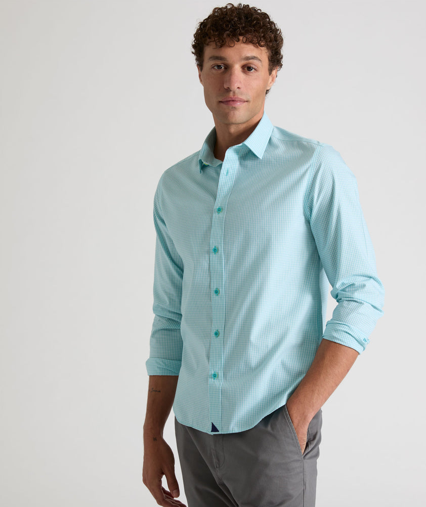 Model is wearing UNTUCKit Travelers shirt in purple tiny gingham. 