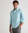 Model is wearing UNTUCKit Travelers shirt in purple tiny gingham. 