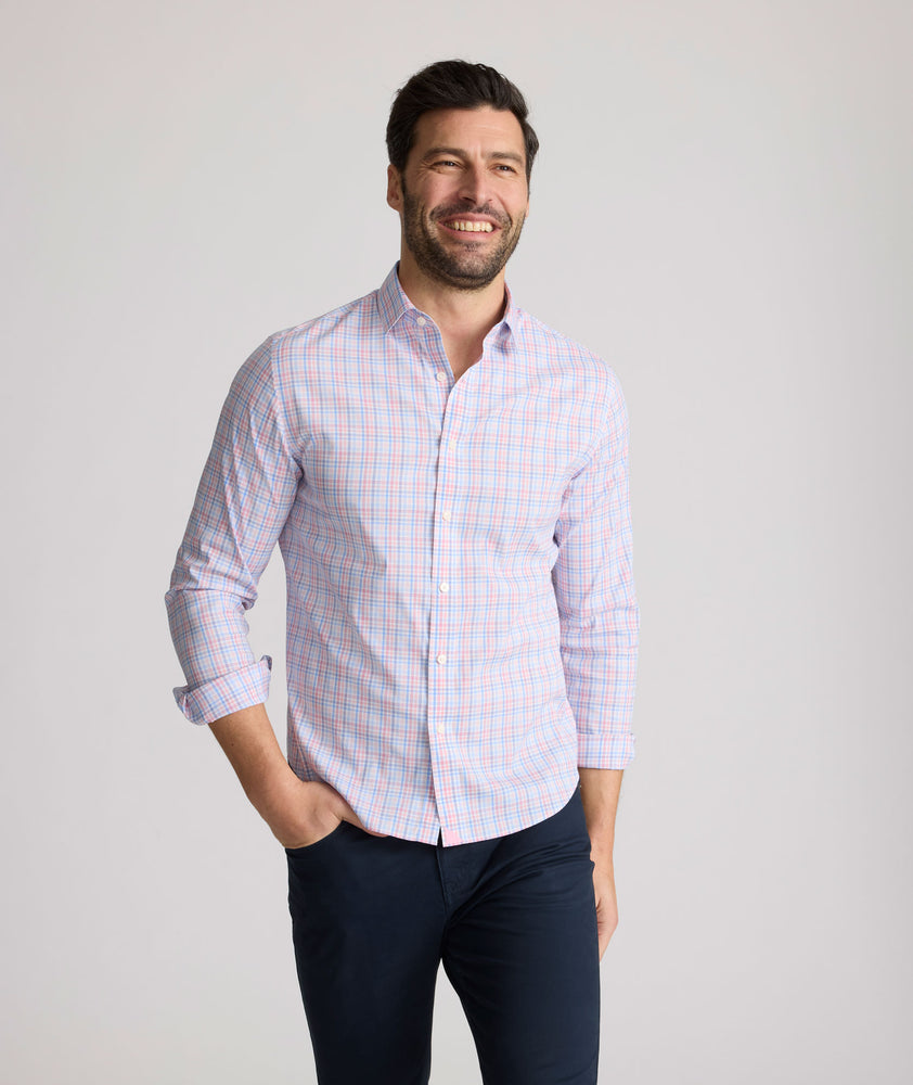 Model is wearing UNTUCKit trembley cottontek orange check shirt. 