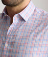 Model is wearing UNTUCKit trembley cottontek orange check shirt. 