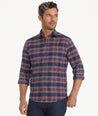 Model is wearing UNTUCKit Wrinkle-Free Performance Flannel Trezari Shirt in Navy Red & White Plaid.