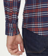 Model is wearing UNTUCKit Wrinkle-Free Performance Flannel Trezari Shirt in Navy Red & White Plaid.