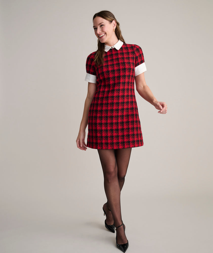 Model is wearing UNTUCKit Valentina dress in red tweed houndstooth. 