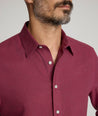 Model is wearing UNTUCKit Veneto wrinkle-free shirt in Rhododendron. 
