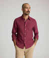 Model is wearing UNTUCKit Veneto wrinkle-free shirt in Rhododendron. 