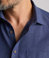 Model wearing an UNTUCKit Navy Wrinkle-Resistant Linen Vin Santo Shirt