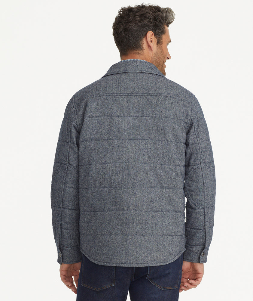 Model is wearing UNTUCKit Vinifera jacket in navy.