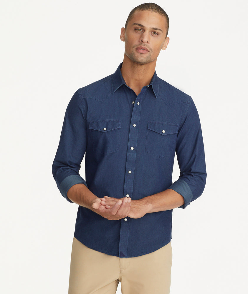 Model is wearing UNTUCKit Wrinkle-Free Wade Shirt in Western Dark Blue Chambray.