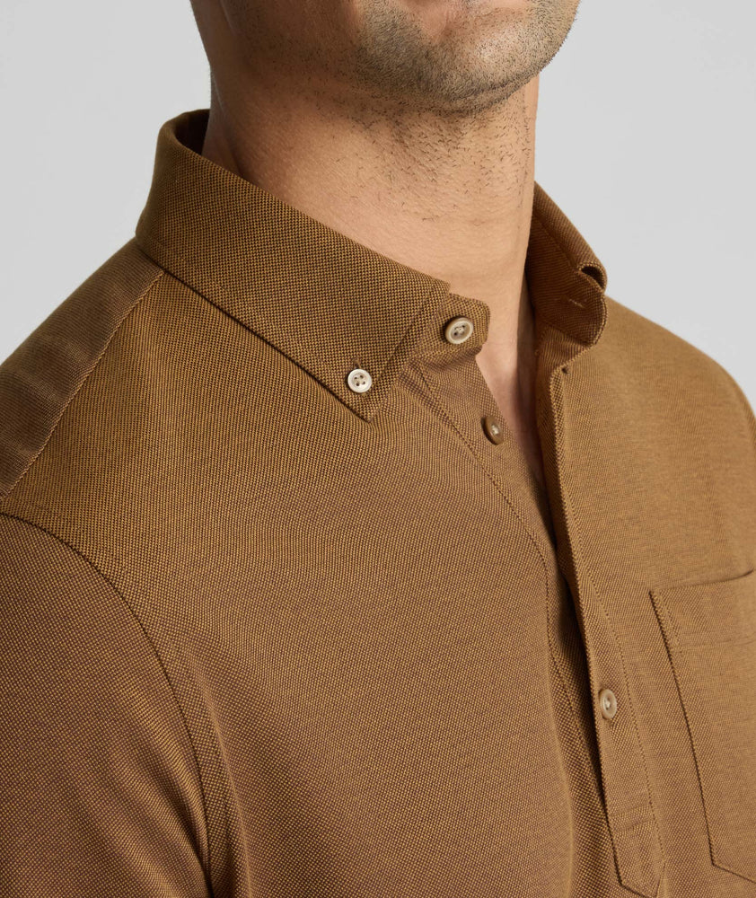 Model is wearing UNTUCKit Classic Cotton Long-Sleeve Polo in brown. 